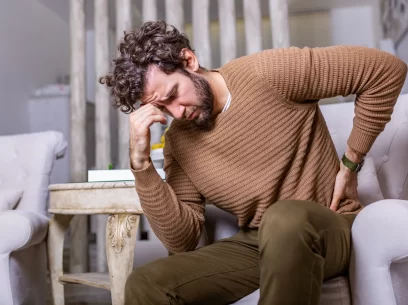 Male patient with lower back pain needing an osteopath