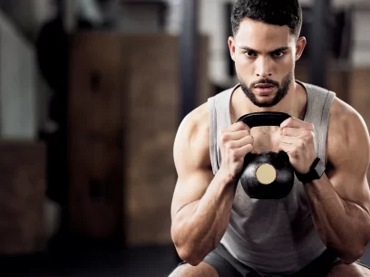 Male with a dumbbell doing squat exercises
