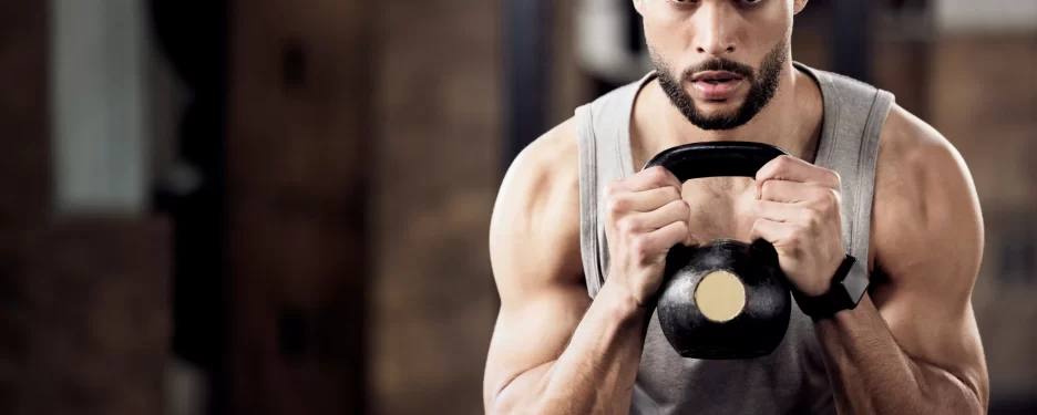 Male with a dumbbell doing squat exercises