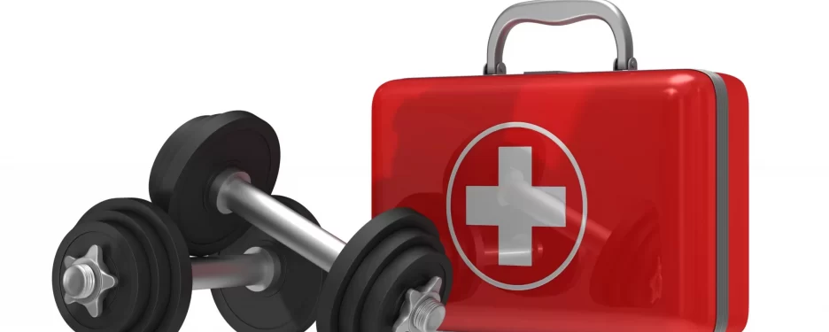 First aid kit with dumbbells on the side representing safety and injury prevention when exercising at the gym.
